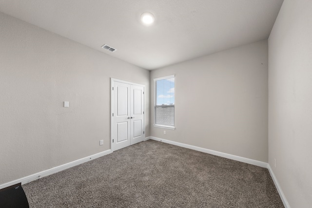 spare room featuring carpet floors