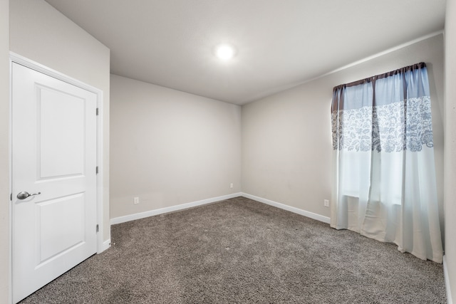 empty room with dark carpet