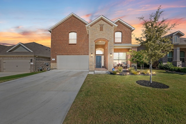 view of front of home with a garage and a lawn