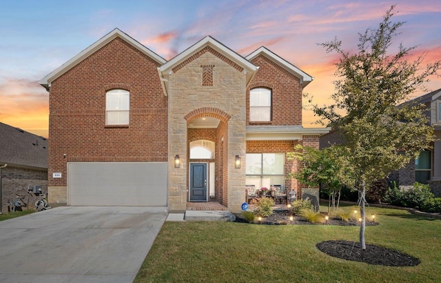 view of front of home with a garage and a lawn