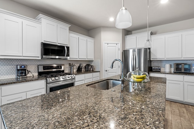 kitchen featuring appliances with stainless steel finishes, sink, and white cabinets