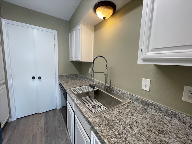 kitchen with dark hardwood / wood-style floors, white cabinetry, and sink