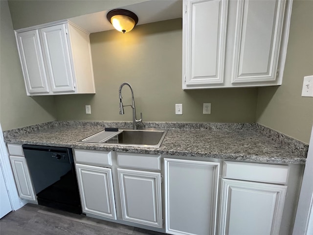 kitchen with dark hardwood / wood-style flooring, white cabinetry, dishwasher, and sink