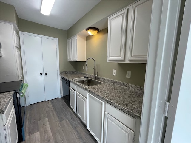 kitchen featuring sink, hardwood / wood-style flooring, white cabinetry, black dishwasher, and white range with electric cooktop