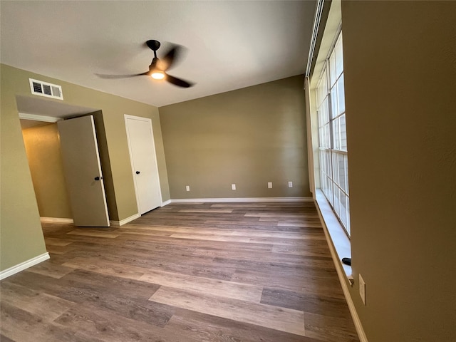 unfurnished bedroom with ceiling fan and hardwood / wood-style floors