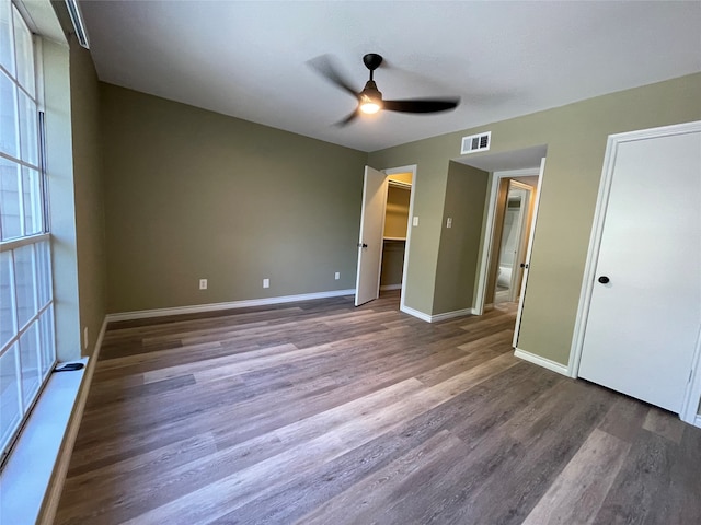 unfurnished bedroom featuring dark hardwood / wood-style floors and ceiling fan