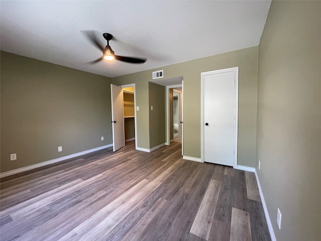 unfurnished bedroom featuring ceiling fan, dark wood-type flooring, and a closet