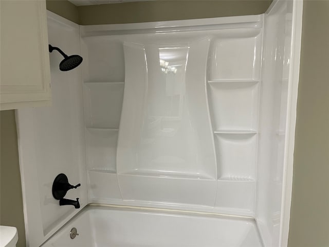 bathroom with bathing tub / shower combination