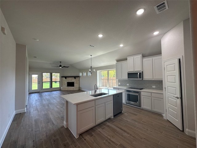 kitchen with plenty of natural light, white cabinetry, sink, and stainless steel appliances