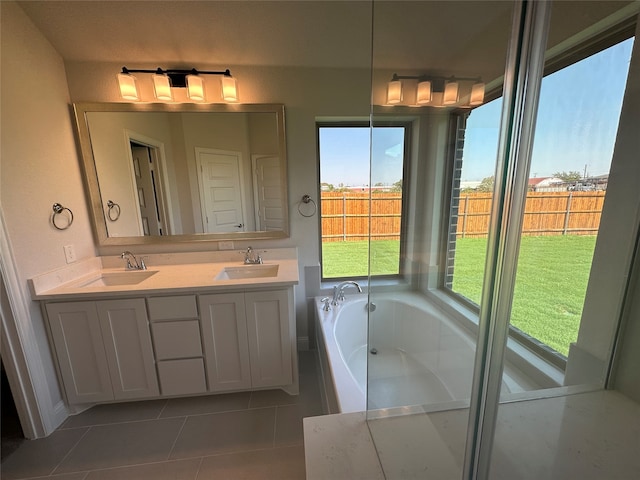 bathroom with tile patterned floors, vanity, and a washtub