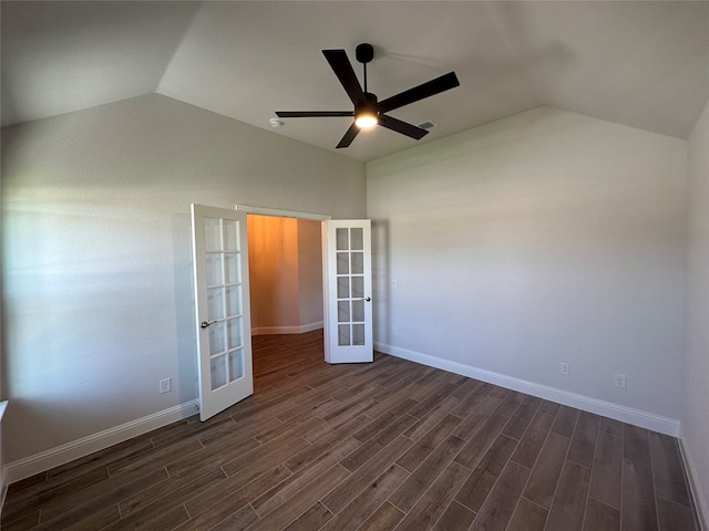 empty room with french doors, dark hardwood / wood-style floors, vaulted ceiling, and ceiling fan