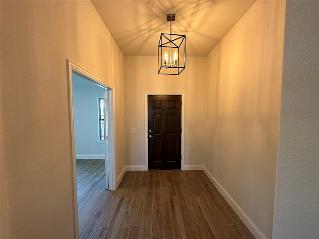 entryway featuring a notable chandelier and dark hardwood / wood-style flooring