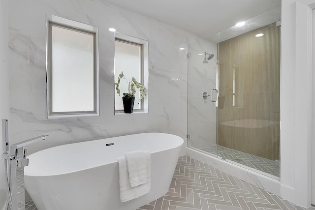 bathroom with plus walk in shower and tile walls