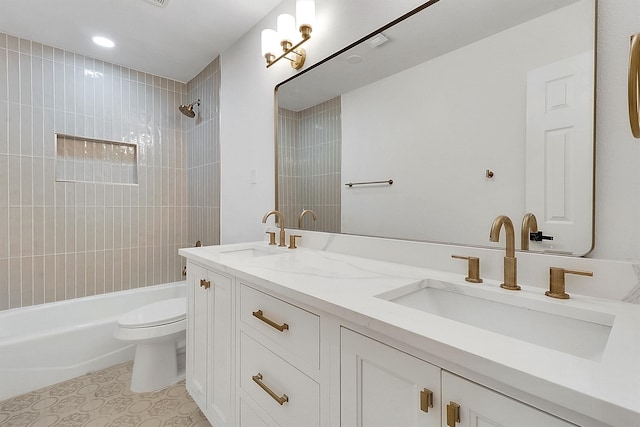 full bathroom with vanity, toilet, and tiled shower / bath