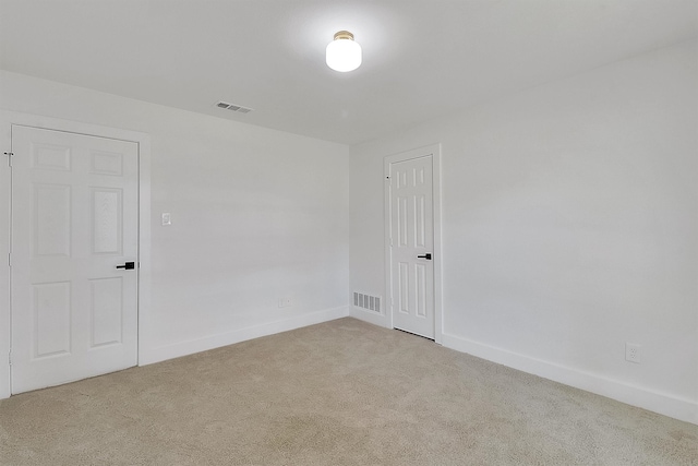 unfurnished room with light colored carpet