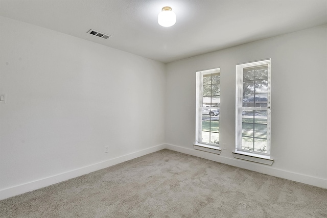 empty room with plenty of natural light and light colored carpet