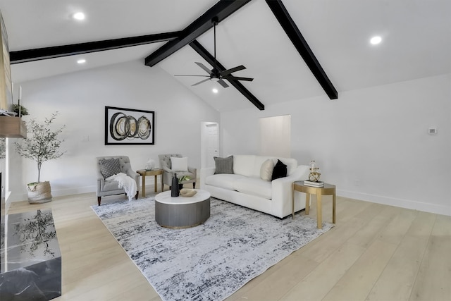 living room featuring ceiling fan, light hardwood / wood-style flooring, and lofted ceiling with beams