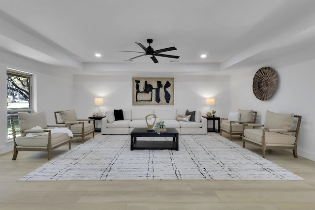 living room featuring light wood-type flooring and ceiling fan