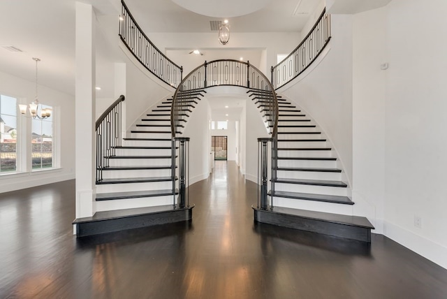 stairs featuring a chandelier and hardwood / wood-style flooring