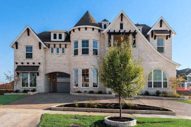 view of front of property with driveway and brick siding