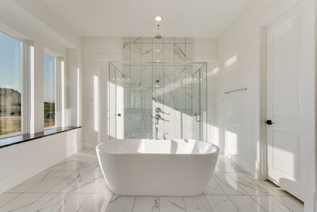 full bath with marble finish floor, baseboards, a soaking tub, and a marble finish shower