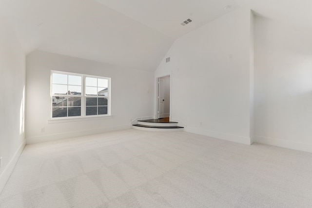 unfurnished living room featuring carpet floors, visible vents, high vaulted ceiling, and baseboards