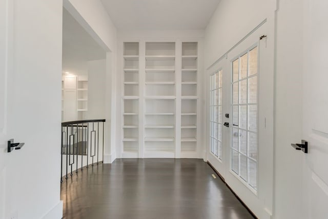 doorway to outside featuring built in shelves, dark wood-type flooring, and french doors