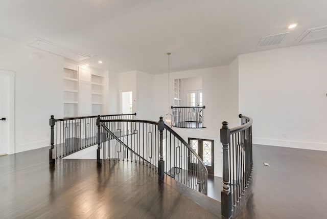 interior space with built in shelves, attic access, visible vents, and baseboards