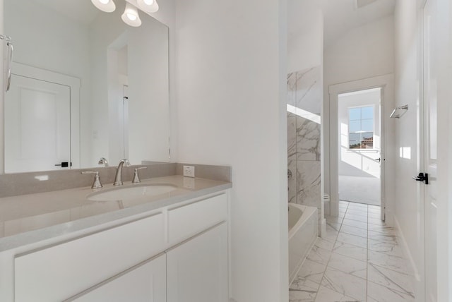 bathroom with toilet, marble finish floor, and vanity