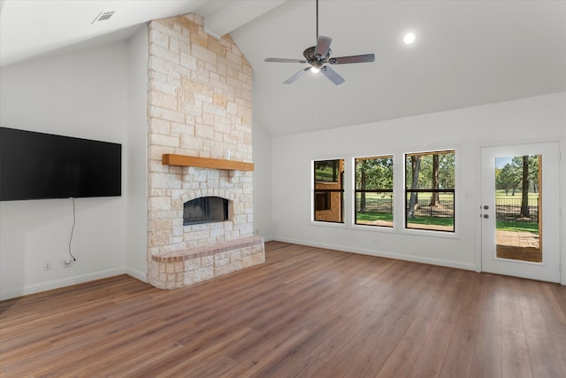 unfurnished living room with wood-type flooring, ceiling fan, high vaulted ceiling, a fireplace, and beam ceiling