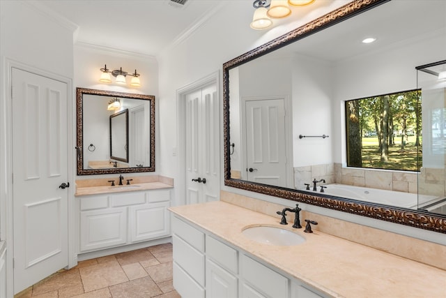 bathroom with vanity, crown molding, and a tub