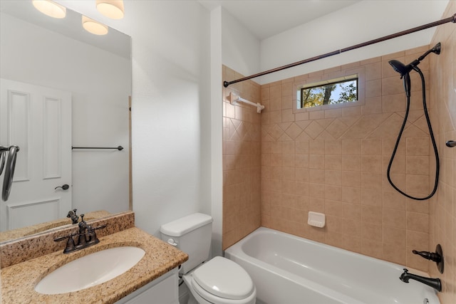 full bathroom with toilet, tiled shower / bath combo, and vanity