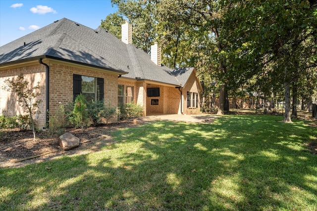 rear view of property with a patio area and a lawn