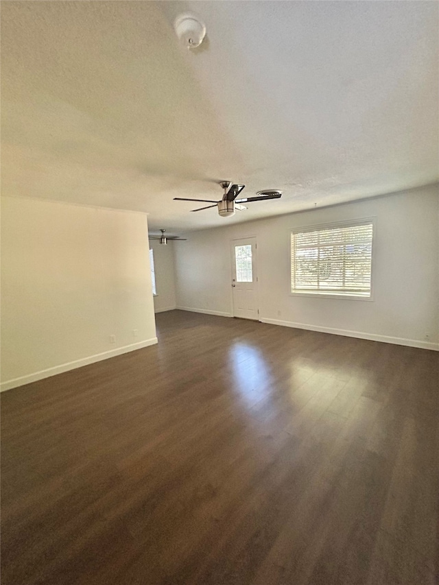 spare room with ceiling fan and dark hardwood / wood-style floors