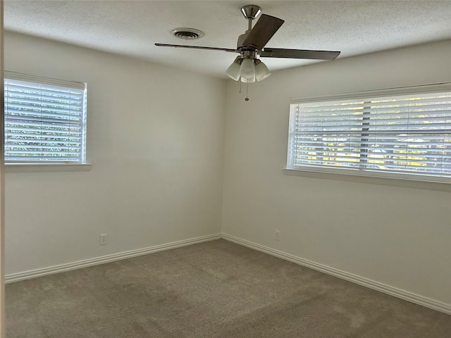 unfurnished room featuring ceiling fan, carpet, and a textured ceiling