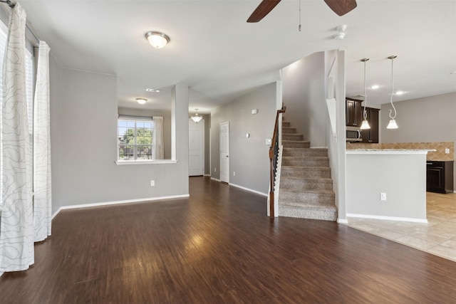 unfurnished living room with ceiling fan and hardwood / wood-style floors