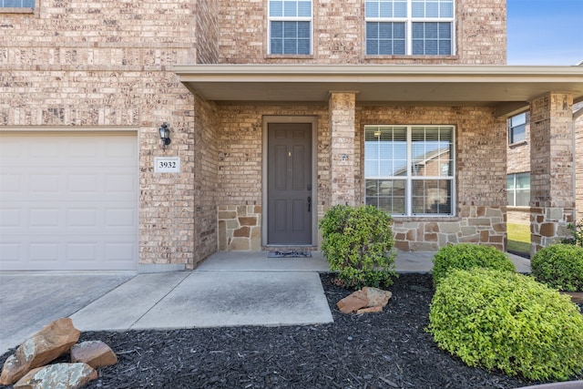 view of exterior entry featuring a garage