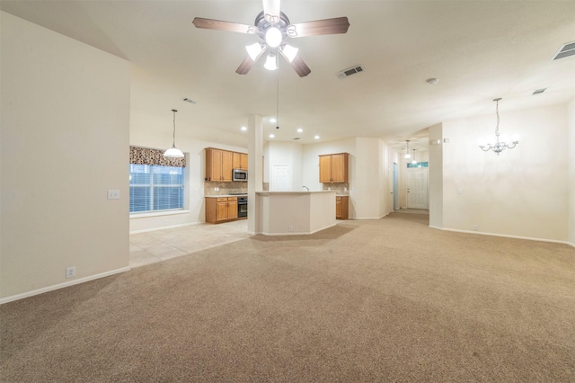 unfurnished living room featuring ceiling fan with notable chandelier and light colored carpet