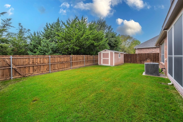 view of yard with a shed and central AC