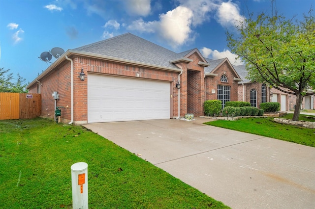 ranch-style home featuring a front yard and a garage