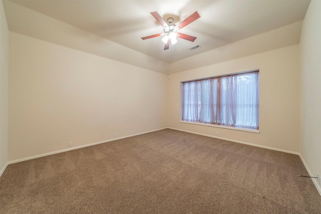 carpeted empty room featuring ceiling fan and lofted ceiling