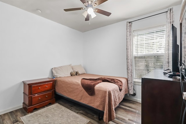 bedroom featuring ceiling fan and dark hardwood / wood-style floors