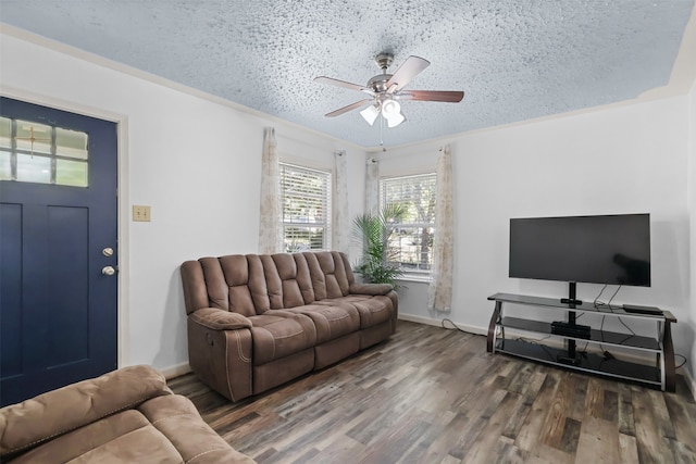 living room featuring crown molding, ceiling fan, dark hardwood / wood-style floors, and a textured ceiling