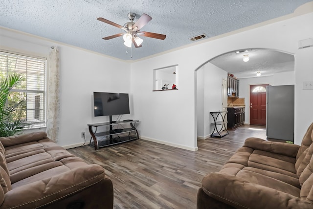 living room featuring ceiling fan, hardwood / wood-style floors, and a textured ceiling