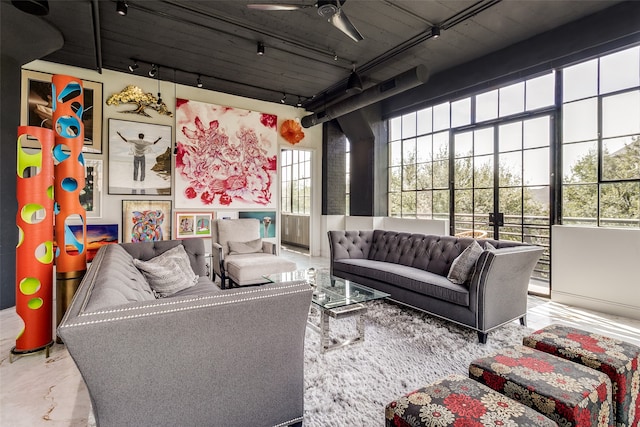 living room with ceiling fan and concrete floors