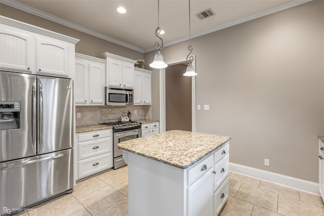 kitchen featuring a kitchen island, white cabinets, light tile patterned floors, and appliances with stainless steel finishes