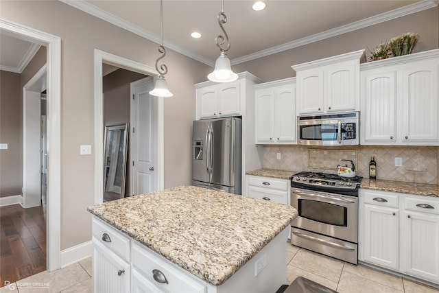 kitchen with white cabinetry, pendant lighting, a center island, and stainless steel appliances