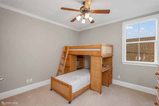 carpeted bedroom featuring ceiling fan and crown molding