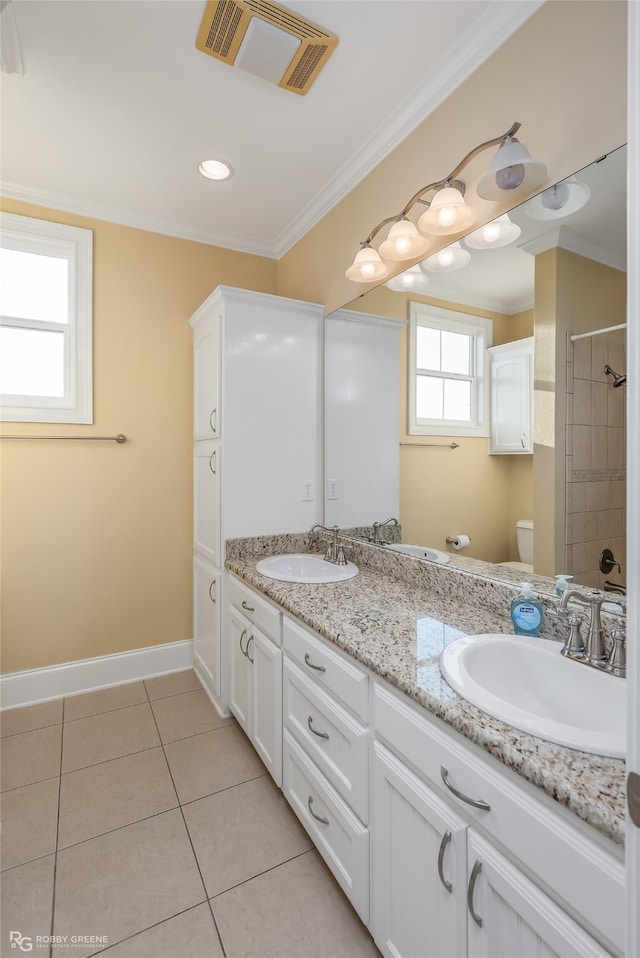 bathroom with tile patterned floors, vanity, toilet, and crown molding