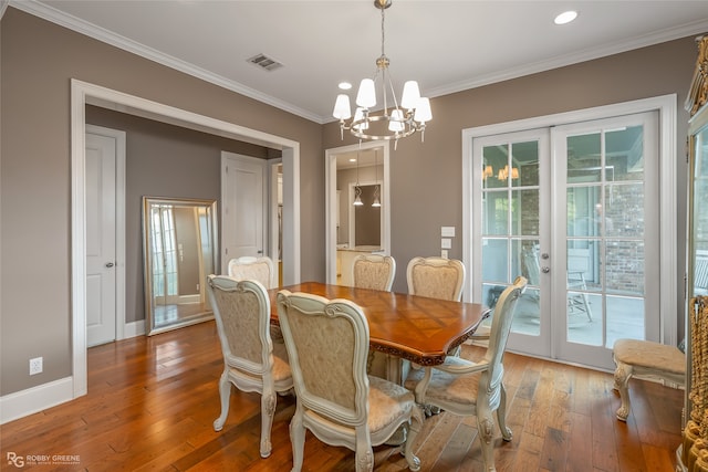 dining area with a healthy amount of sunlight, french doors, wood-type flooring, and ornamental molding